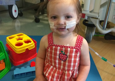 Picture of Leah in the PICU over 4th of July holiday when she was about 18 months old